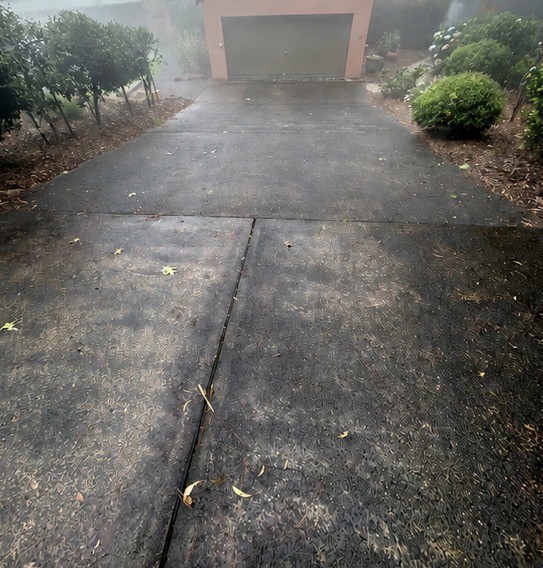 Grimy concrete driveway before high pressure cleaning